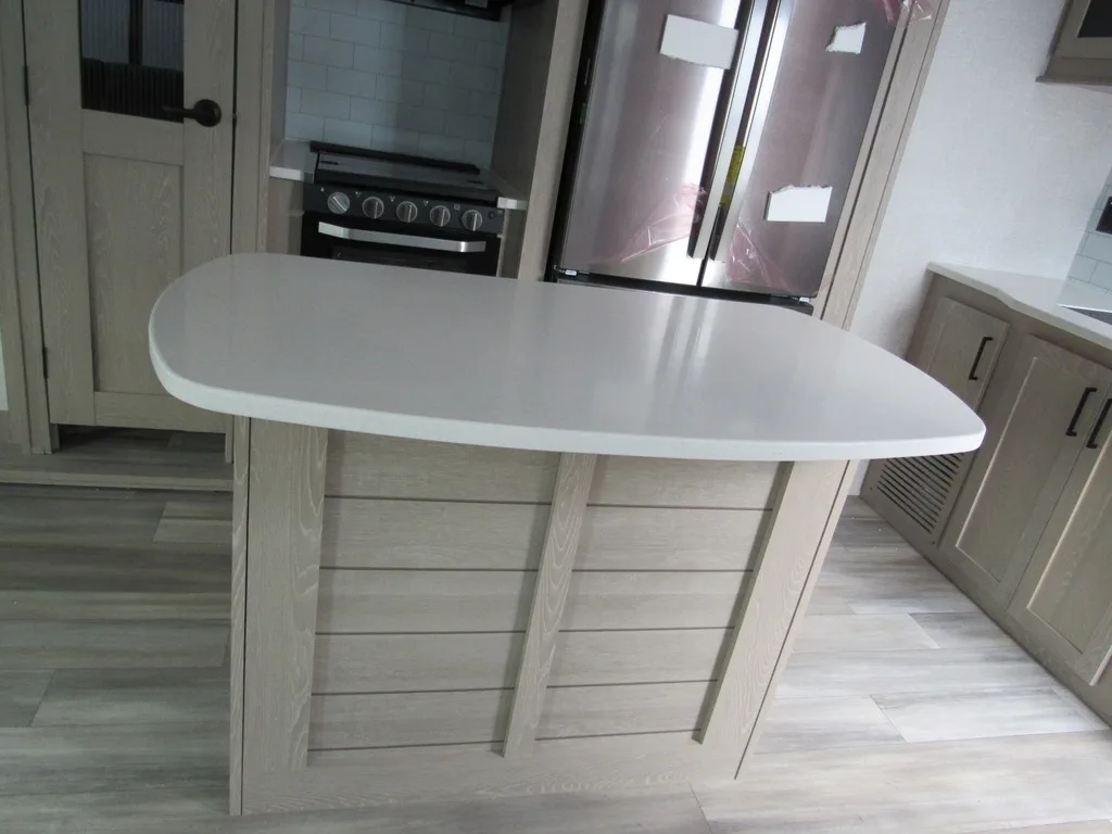 Kitchen with a gas burner, fridge, and cabinets.