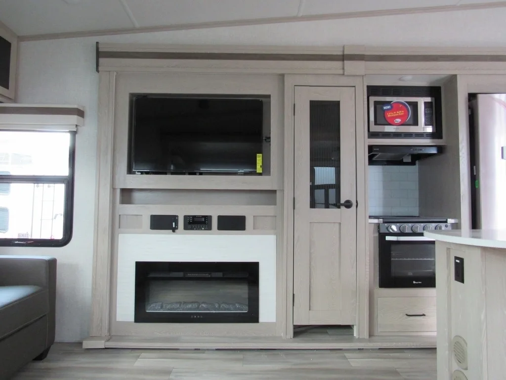 Entertainment center with a TV and a fireplace.