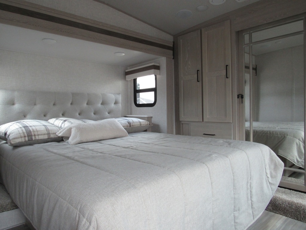 Bedroom with a queen size bed and a closet.