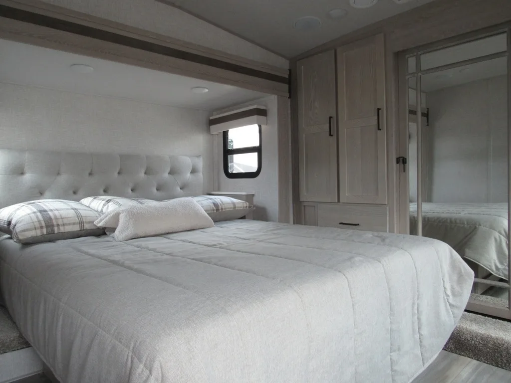 Bedroom with a queen size bed and a closet.