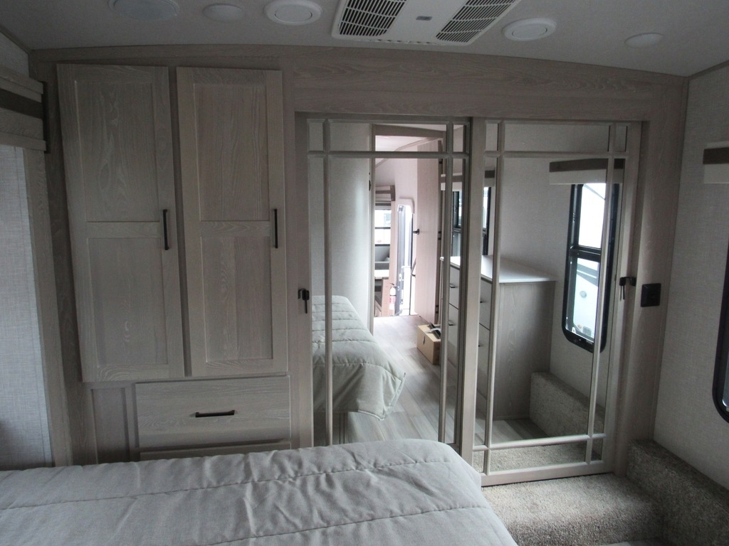 Bedroom with a queen size bed and a closet.