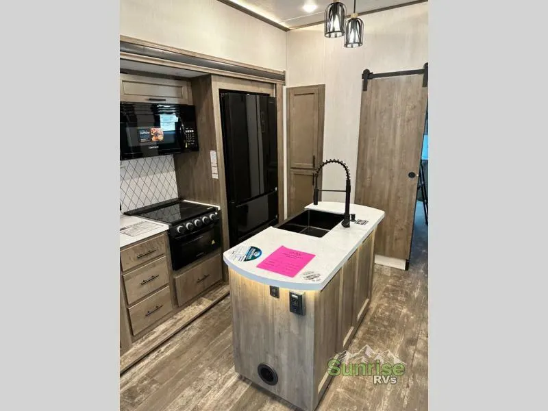 Kitchen with a gas burner, fridge, oven, sink and cabinets.