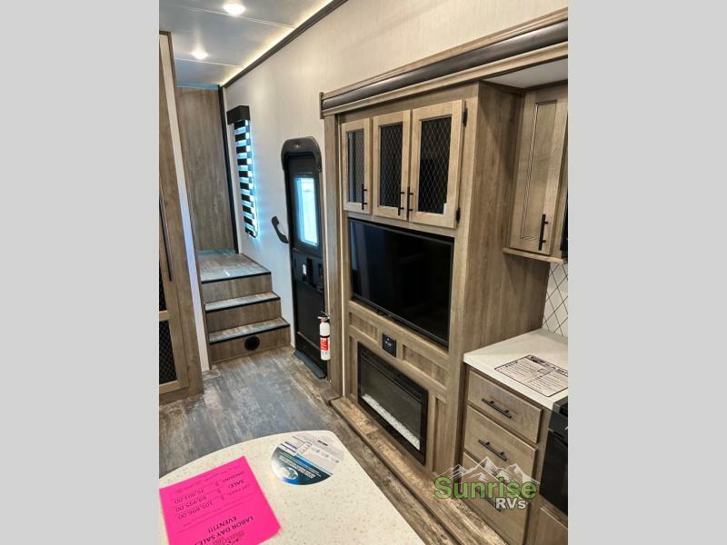 Entertainment center with a TV and a fireplace.