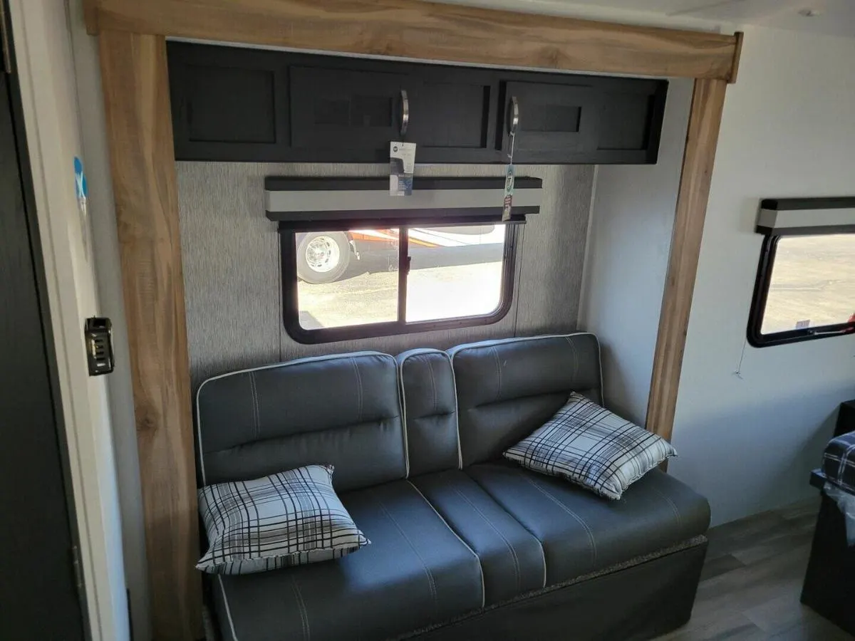 Living space with a sofa and overhead cabinets.