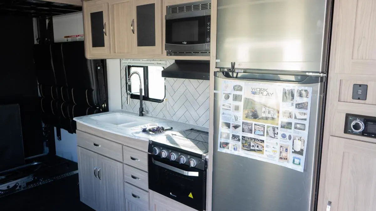 Kitchen with a gas burner, fridge, oven, sink and cabinets.