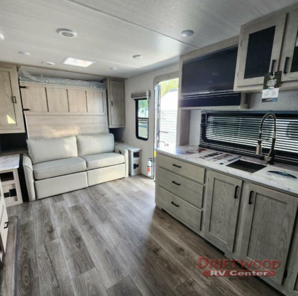 Living space with overhead cabinets.