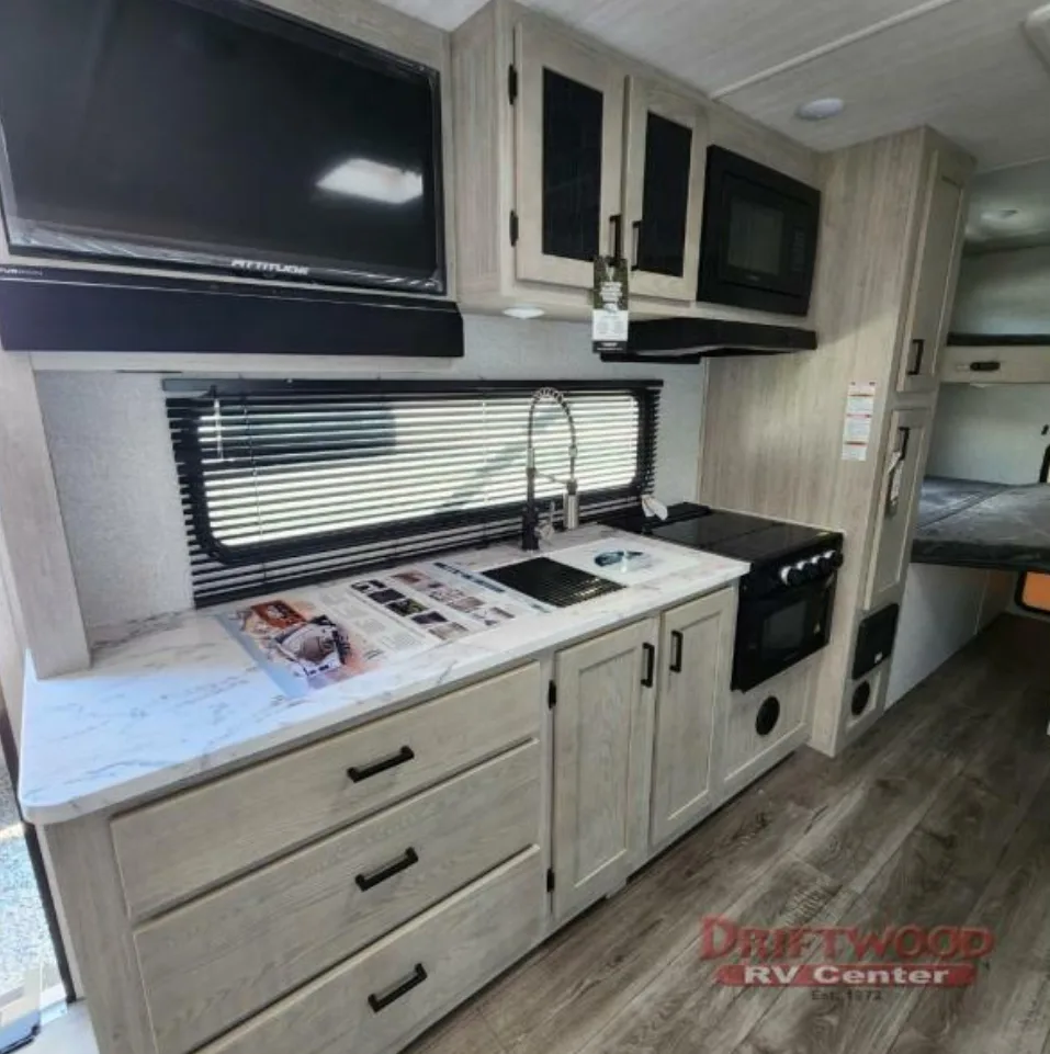 Kitchen with a gas burner, fridge, oven, sink and cabinets.