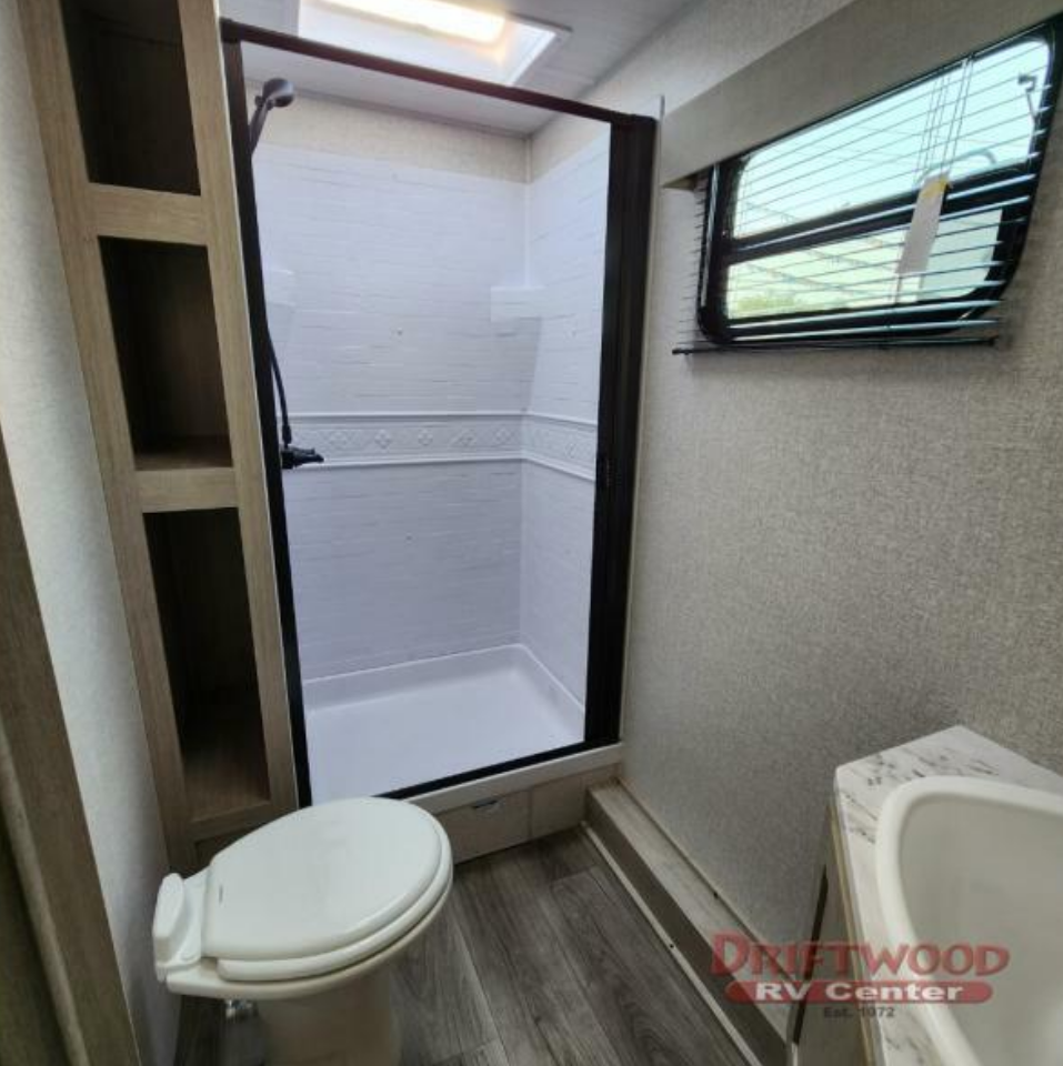 Bathroom with a sink, toilet and a walk-in shower.