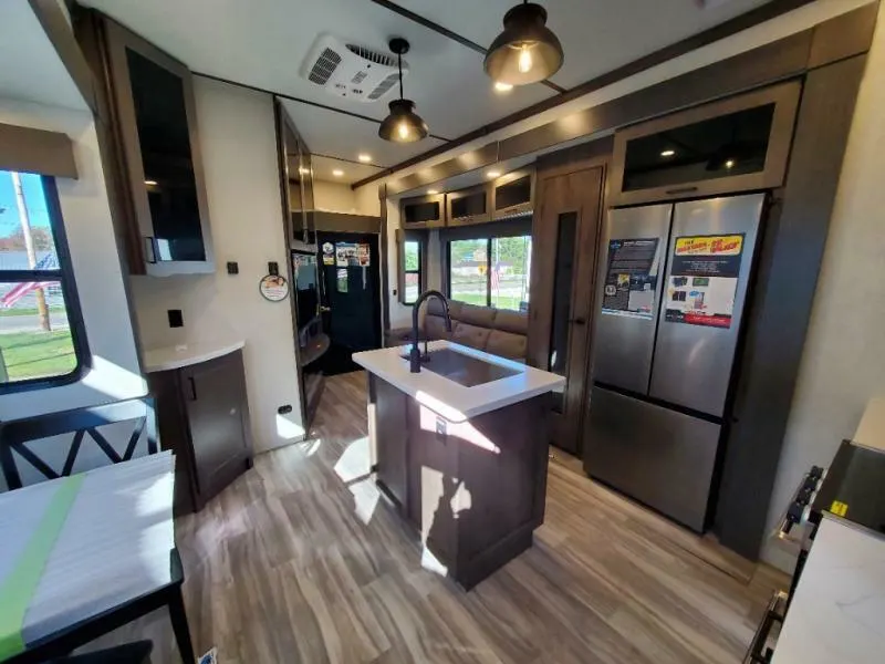 Interior view of the RV with a dinette, living space and a kitchen.