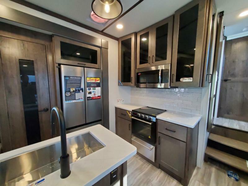 Kitchen with a gas burner, fridge, oven, sink and cabinets.