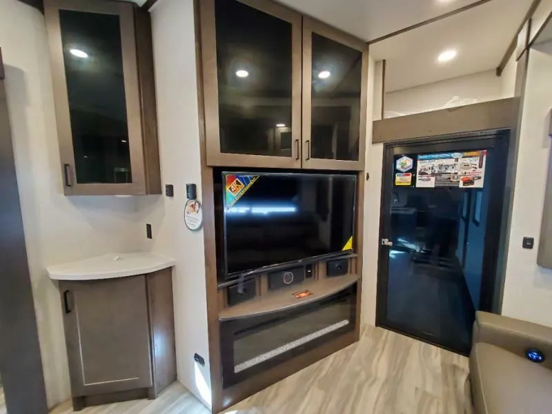 Entertainment center with a TV and a fireplace.