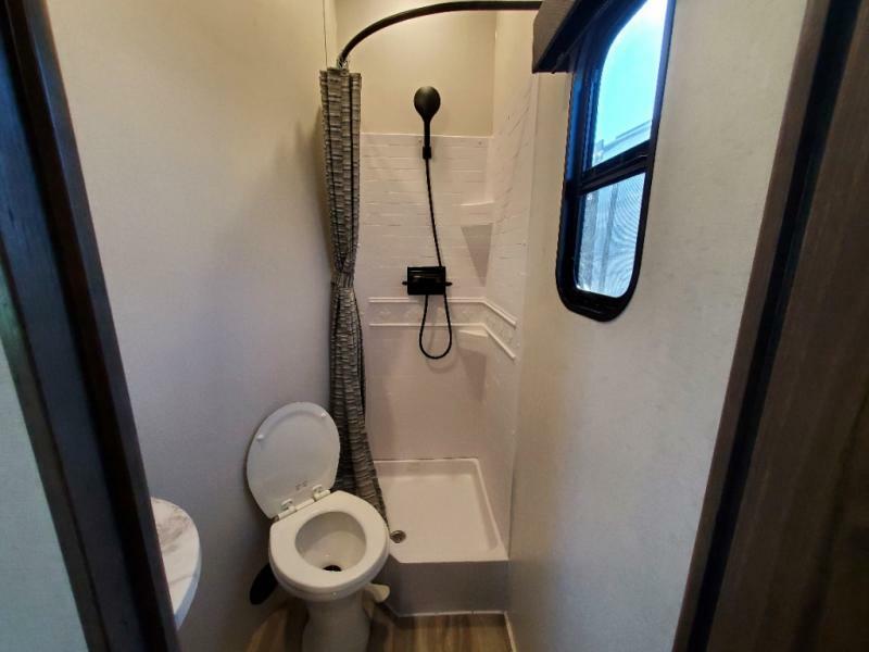 Bathroom with a sink, toilet and a walk-in shower.