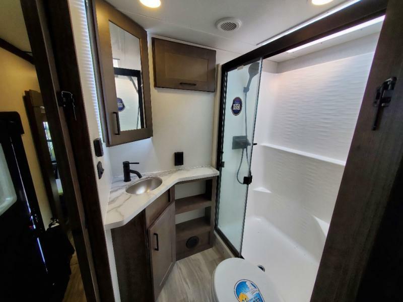 Bathroom with a sink, toilet and a walk-in shower.