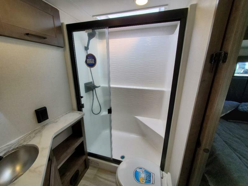 Bathroom with a sink, toilet and a walk-in shower.