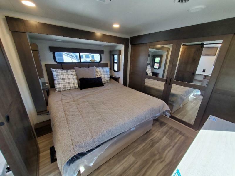 Bedroom with a king size bed and a closet.