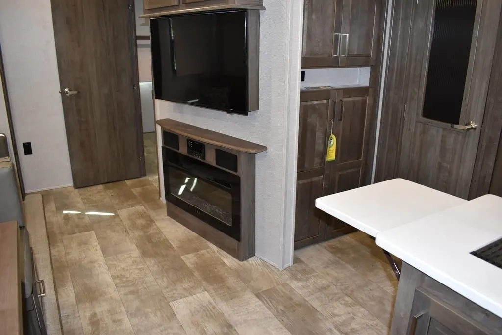 Entertainment center with a TV and a fireplace.