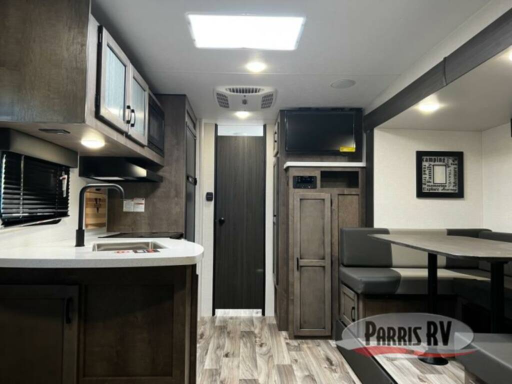 Interior view of the RV with a dinette and a kitchen.