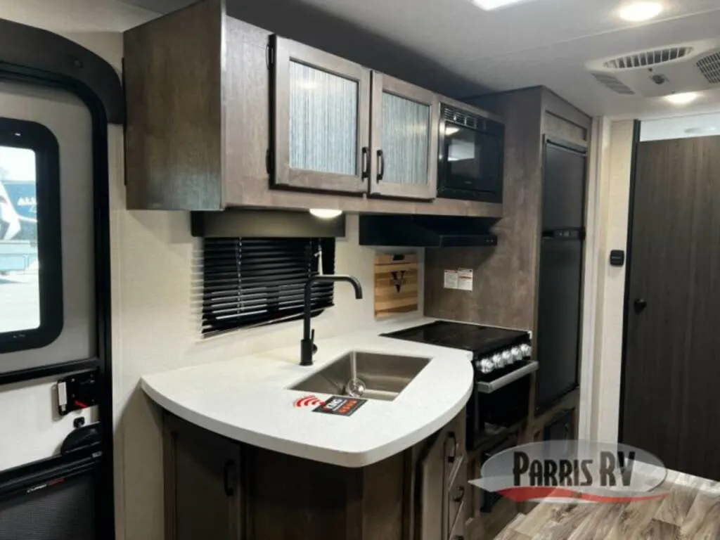 Kitchen with a gas burner, fridge, oven, sink and cabinets.