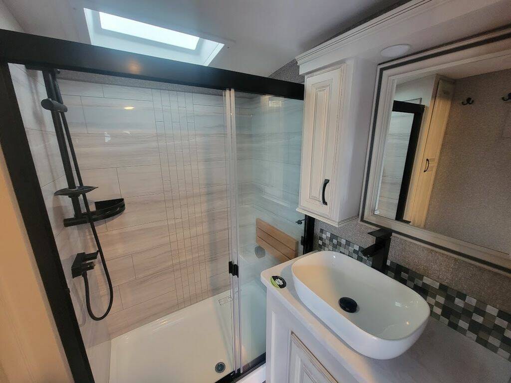 Bathroom with a sink and a walk-in shower.