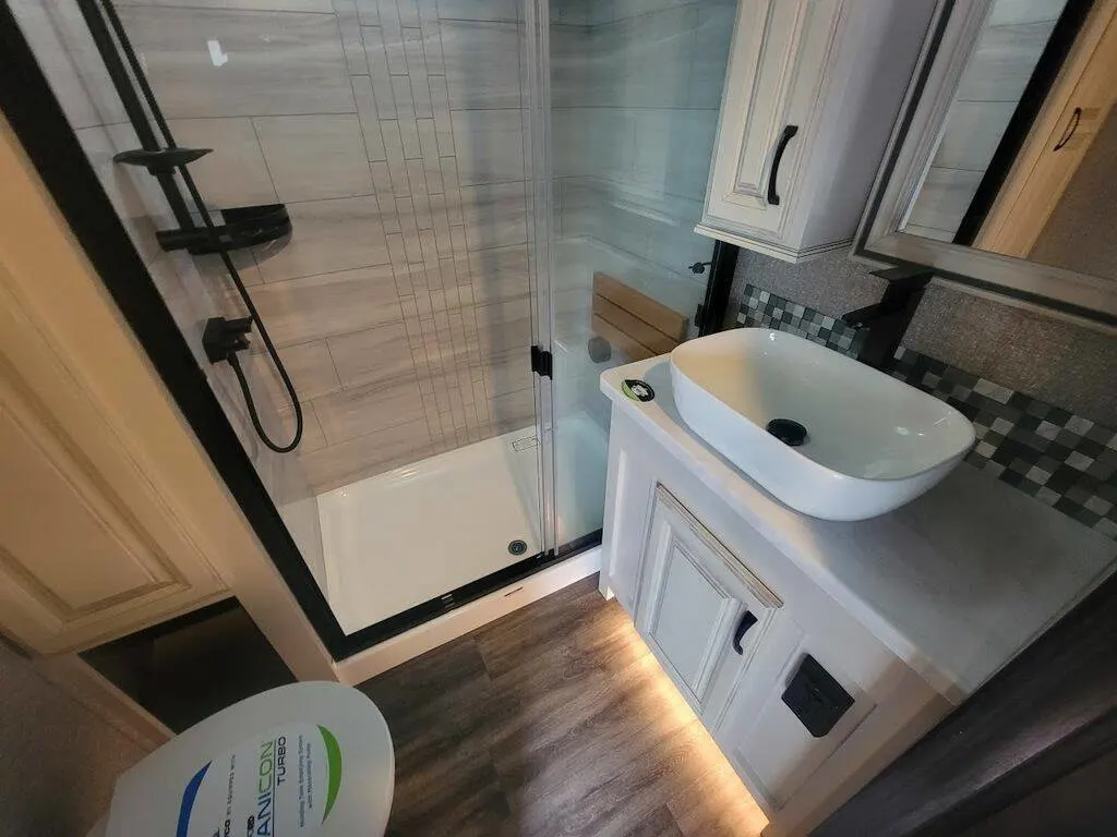 Bathroom with a sink, toilet and a walk-in shower.