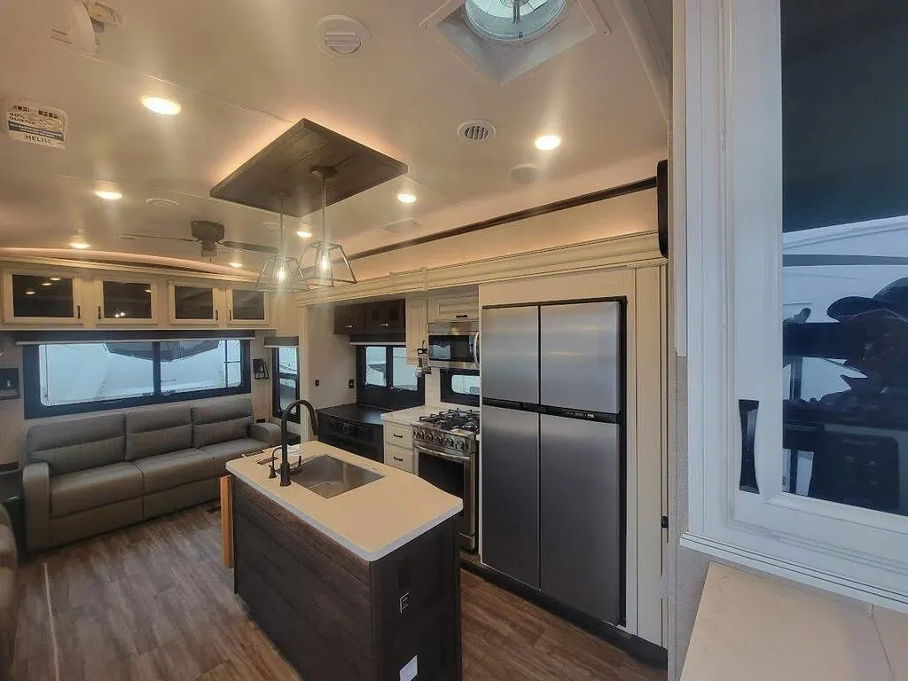 Kitchen with a gas burner, fridge, oven, sink and cabinets.