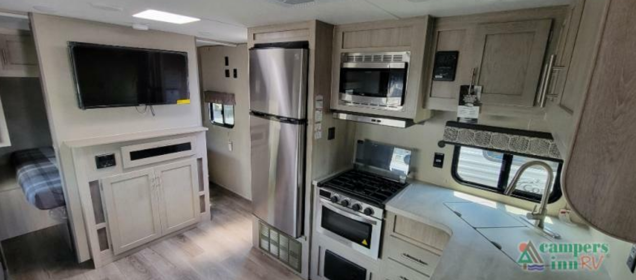 Kitchen with a gas burner, fridge, oven, sink and cabinets.