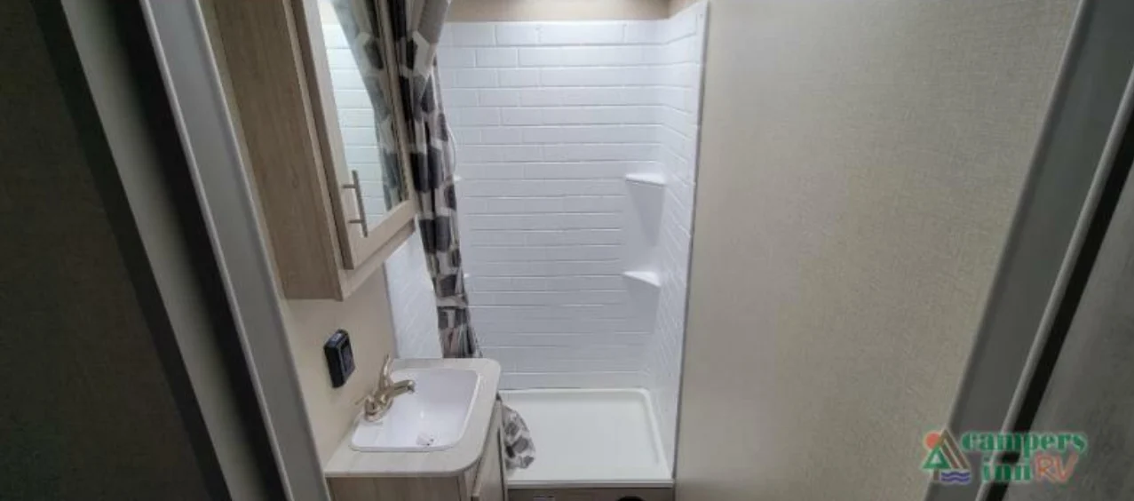 Bathroom with a sink and a walk-in shower.