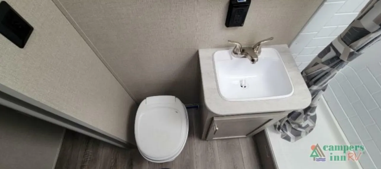 Bathroom with a sink, toilet and a walk-in shower.