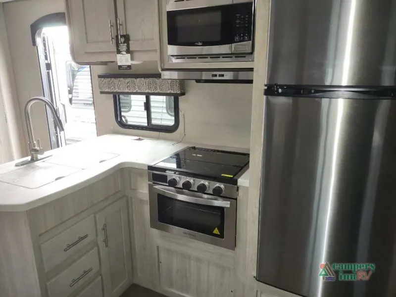 Kitchen with a gas burner, fridge, oven, sink and cabinets.