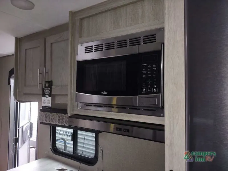 Kitchen with a fridge, oven, and cabinets.