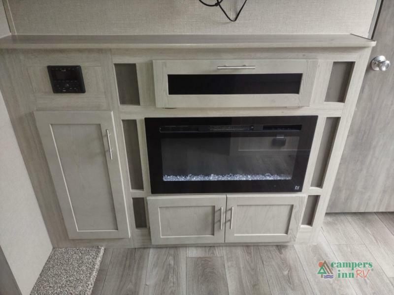 Entertainment center with a fireplace.