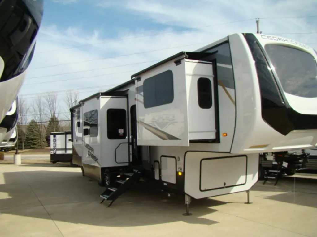 Side view of the New 2022 Forest River Cedar Creek 371FL Fifth Wheel RV.