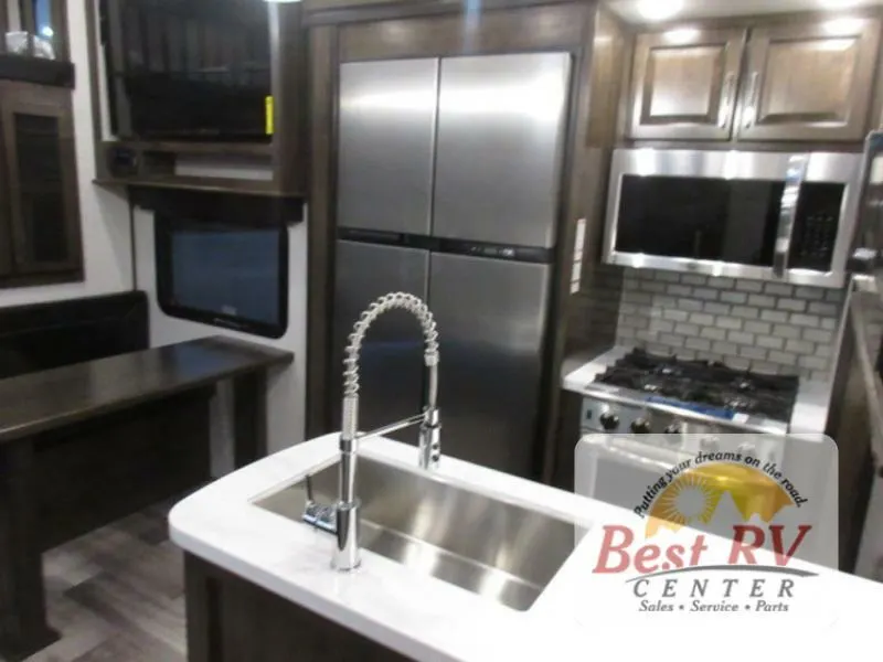 Kitchen with a gas burner, fridge, oven, sink and cabinets.