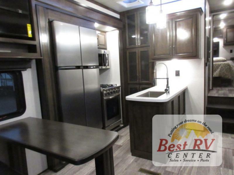 Interior view of the RV with a dinette and a kitchen.