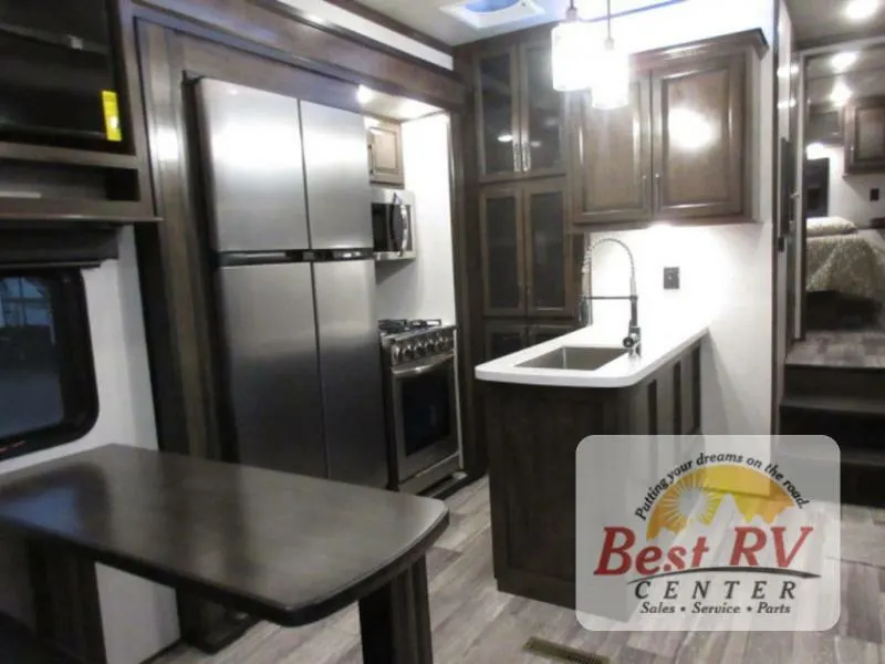 Interior view of the RV with a dinette and a kitchen.