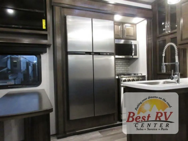 Kitchen with a gas burner, fridge, oven, sink and cabinets.