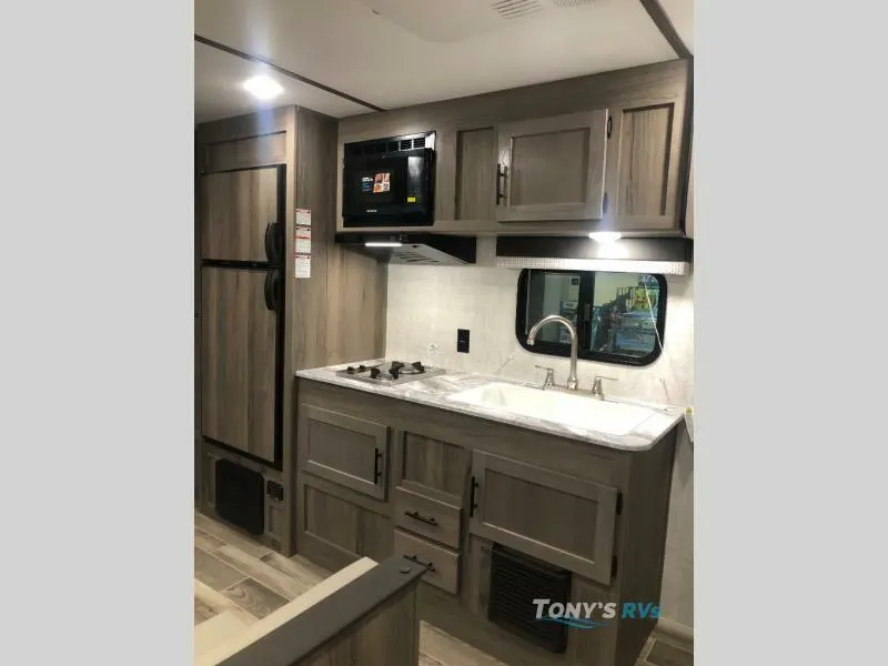 Kitchen with a gas burner, fridge, oven, sink and cabinets.