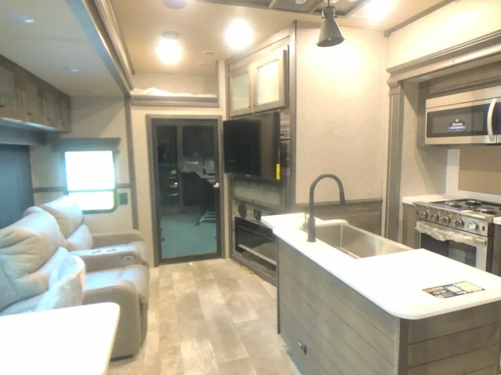 Interior view of the RV with a living space and a kitchen.