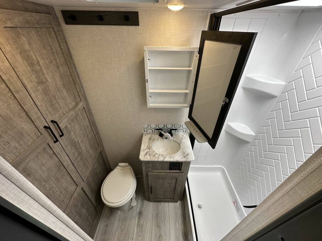 Bathroom with a sink, toilet and a shower.