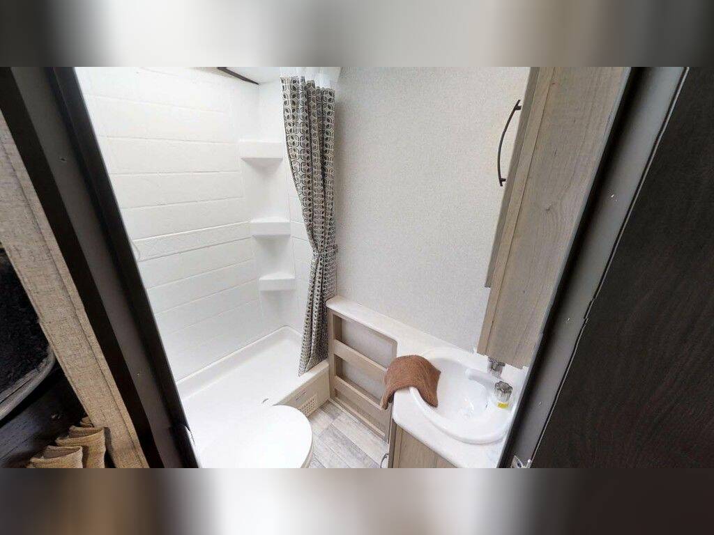 Bathroom with a sink, toilet and a walk-in shower.