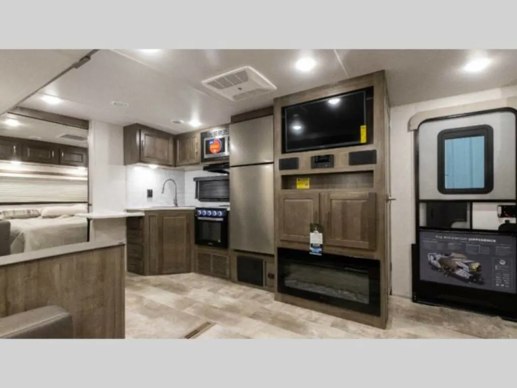 Kitchen with a gas burner, fridge, oven, sink and cabinets.