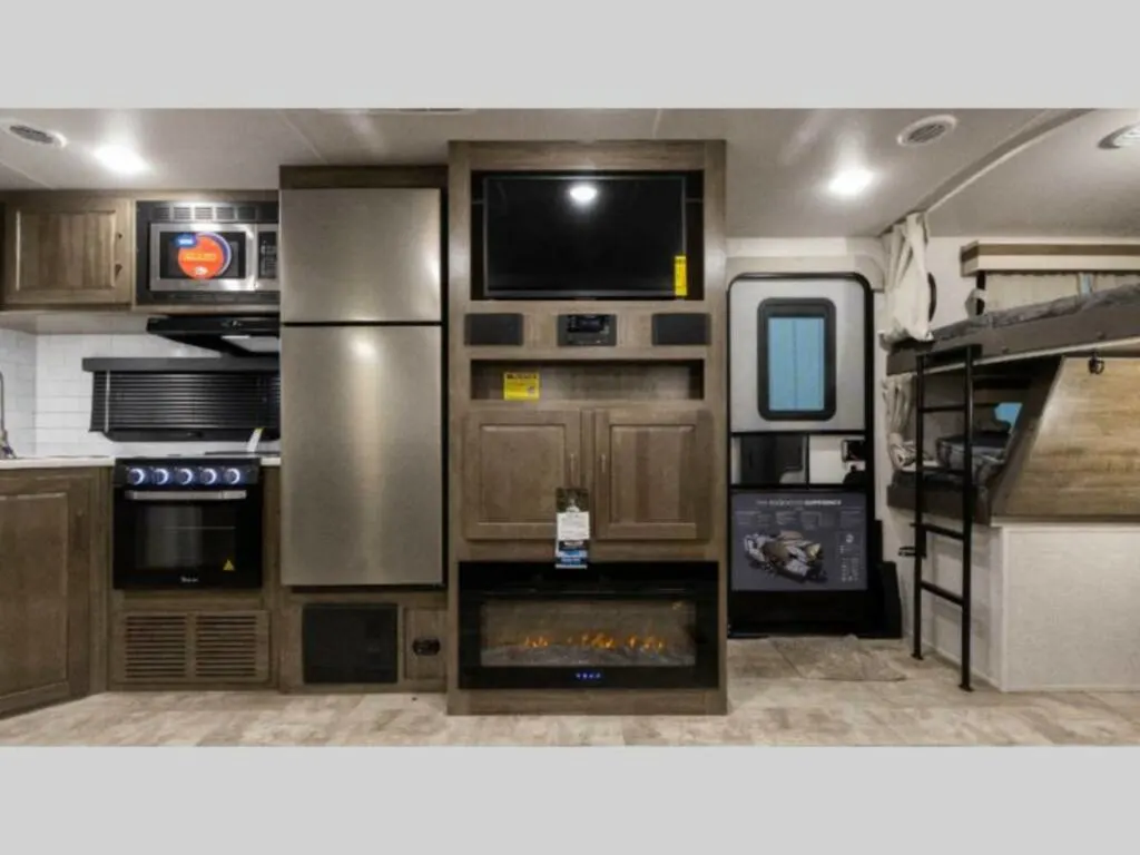 Kitchen with a gas burner, fridge, oven, and cabinets.