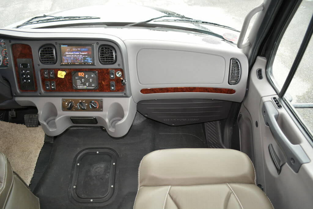 Passenger seat with a beige leather chair.