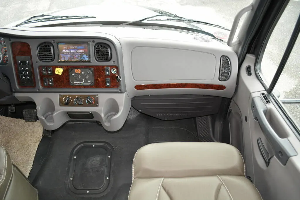 Passenger seat with a beige leather chair.