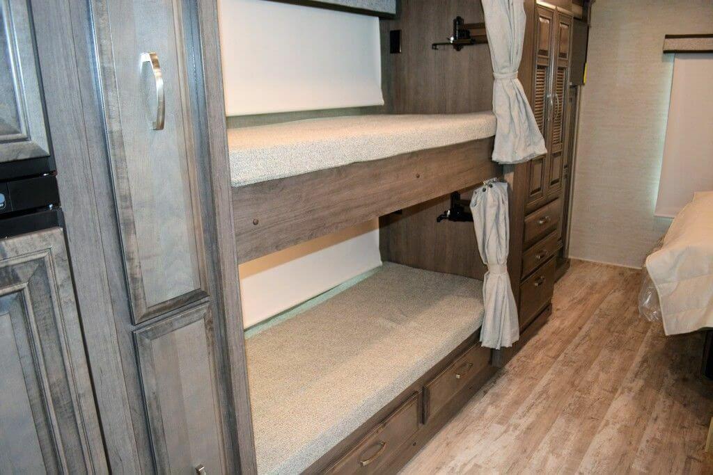 Bunk bed with attached cabinet.