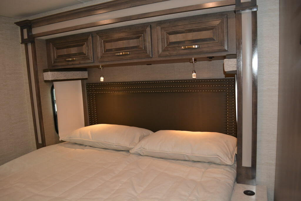 Bedroom with overhead cabinets fixed above the bed.