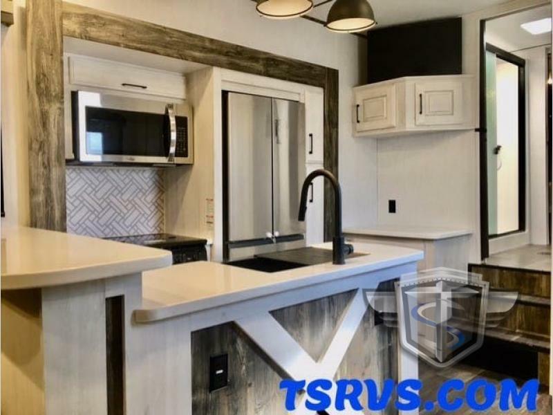 Kitchen with a gas burner, fridge, oven, sink and cabinets.