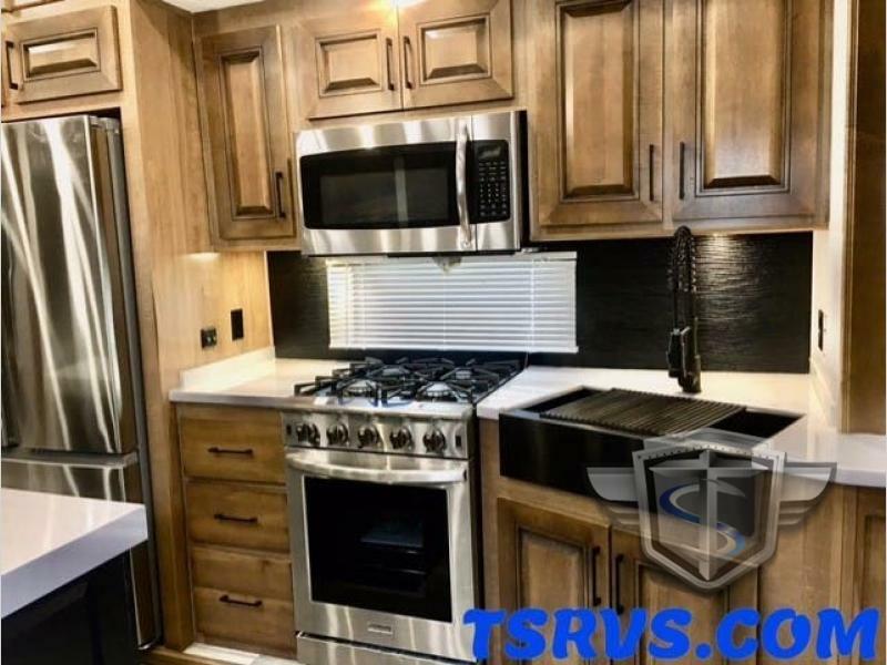 Kitchen with a gas burner, fridge, oven, sink and cabinets.