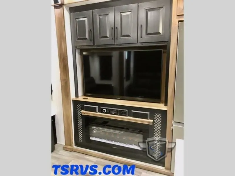 Entertainment center with a TV and a fireplace.