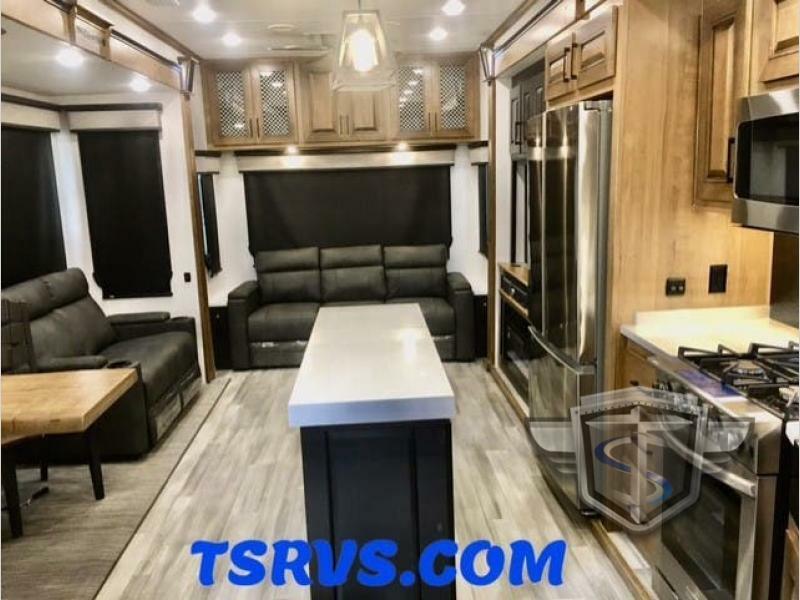 Interior view of the RV with a dinette, living space and a kitchen.